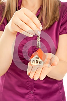 Woman's hands holding house and keys