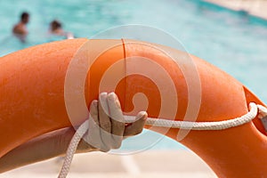 WomanÂ´s hands holding a lifesaver float