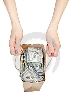 Woman`s hands holding paper bag with money. Isolated on white