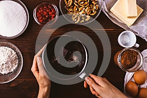 Woman's hands holding stewpan with chocolate