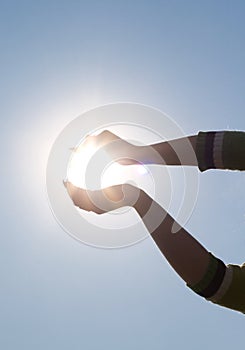 Woman's hands holding sun