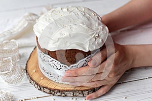 Woman`s hands holding a traditional Easter cake -