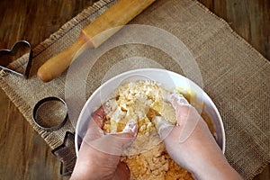 Woman`s hands are kneading shortbread dough