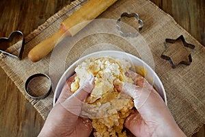Woman`s hands are kneading shortbread dough