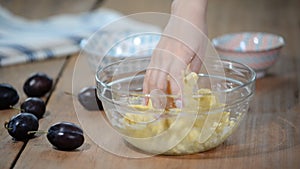 Woman`s hands are kneading shortbread dough on a kitchen table.