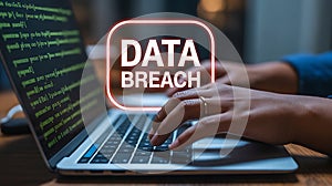 Woman's hands on laptop keyboard with DATABREACH notification and code data breach