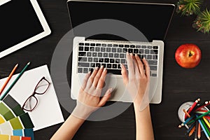 Woman`s hands on laptop keyboard, top view