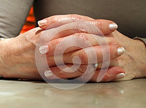 Woman's Hands linked on table