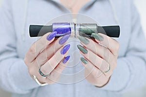 Woman\'s hands with long nails and multi-colored manicure