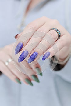 Woman\'s hands with long nails and multi-colored manicure