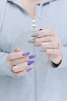 Woman\'s hands with long nails and multi-colored manicure