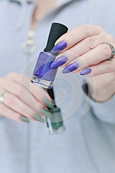 Woman\'s hands with long nails and multi-colored manicure
