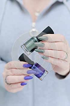 Woman's hands with long nails and multi-colored manicure