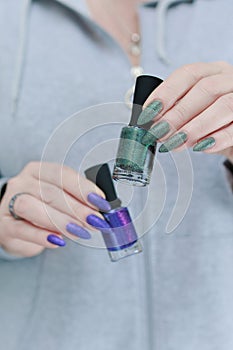 Woman\'s hands with long nails and multi-colored manicure