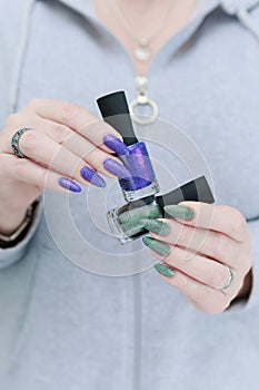 Woman\'s hands with long nails and multi-colored manicure