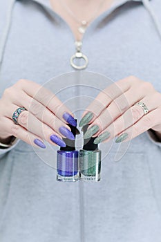 Woman\'s hands with long nails and multi-colored manicure