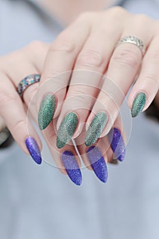 Woman\'s hands with long nails and multi-colored manicure