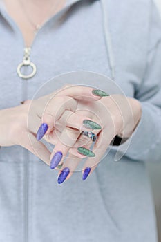 Woman's hands with long nails and multi-colored manicure