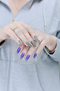 Woman's hands with long nails and multi-colored manicure