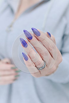 Woman\'s hands with long nails and multi-colored manicure