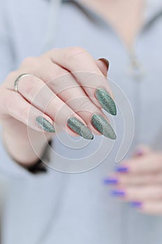 Woman\'s hands with long nails and multi-colored manicure