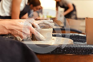 Woman`s hands making pottery circle