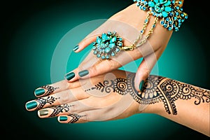 Woman's hands with mehndi tattoo