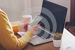 Woman`s hands with mobile phone in workspace. Businesswoman with mobile phone organizing projects