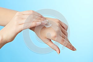 Woman's hands in moisturizer cream