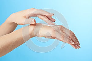 Woman's hands in moisturizer cream