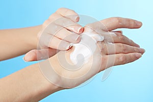 Woman's hands in moisturizer cream