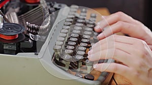 Woman`s hands on an old typewriter
