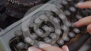 Woman`s hands on an old typewriter