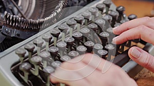 Woman`s hands on an old typewriter