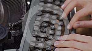 Woman`s hands on an old typewriter
