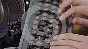 Woman`s hands on an old typewriter