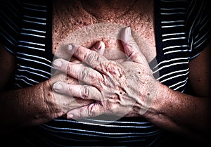 Woman's hands over her chest