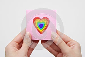 Woman's hands, pink leaf, heart, badge, LGBT