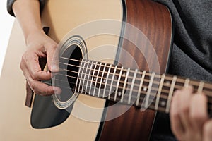 Woman`s hands playing acoustic guitar.