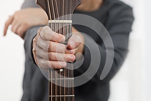 Woman`s hands playing acoustic guitar.