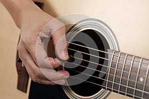 Woman`s hands playing acoustic guitar.