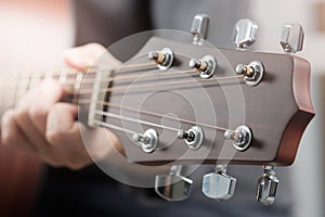 Woman`s hands playing acoustic guitar.