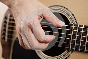 Woman`s hands playing acoustic guitar.