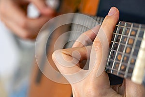 Woman`s hands playing acoustic guitar