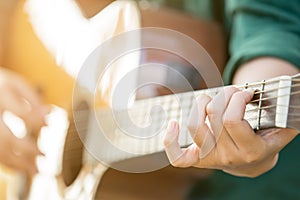 Woman`s hands playing acoustic guitar