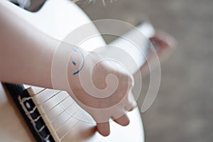 Woman`s hands playing acoustic guitar, close up