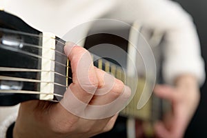 Woman`s hands playing acoustic guitar, close up