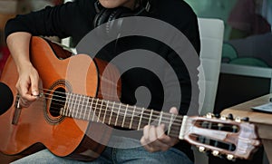 Woman`s hands playing acoustic guitar, close up.concept of recreation