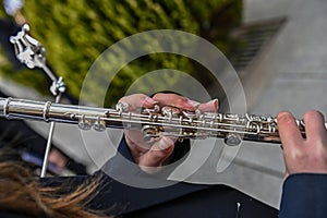 Woman& x27;s hands playing a flute in the orchestra