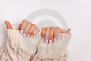 Woman`s hands with proffesional manicure in pastel colors